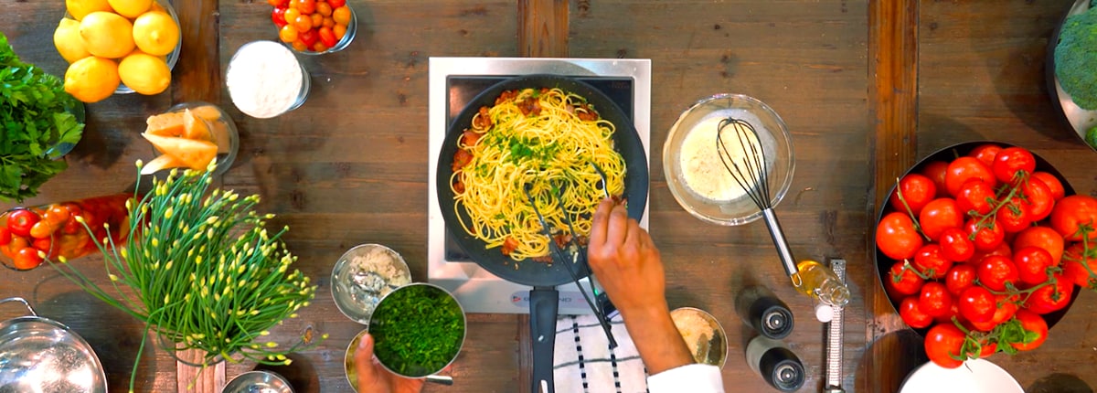 cucina del capitano's pasta carbonara dish being prepared with fresh pasta and vegetables