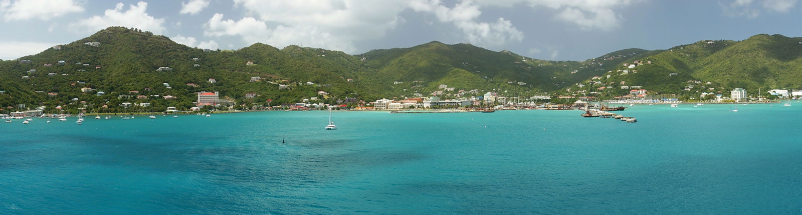 Wide view of the Tortola coastline where the mountains meet the ocean