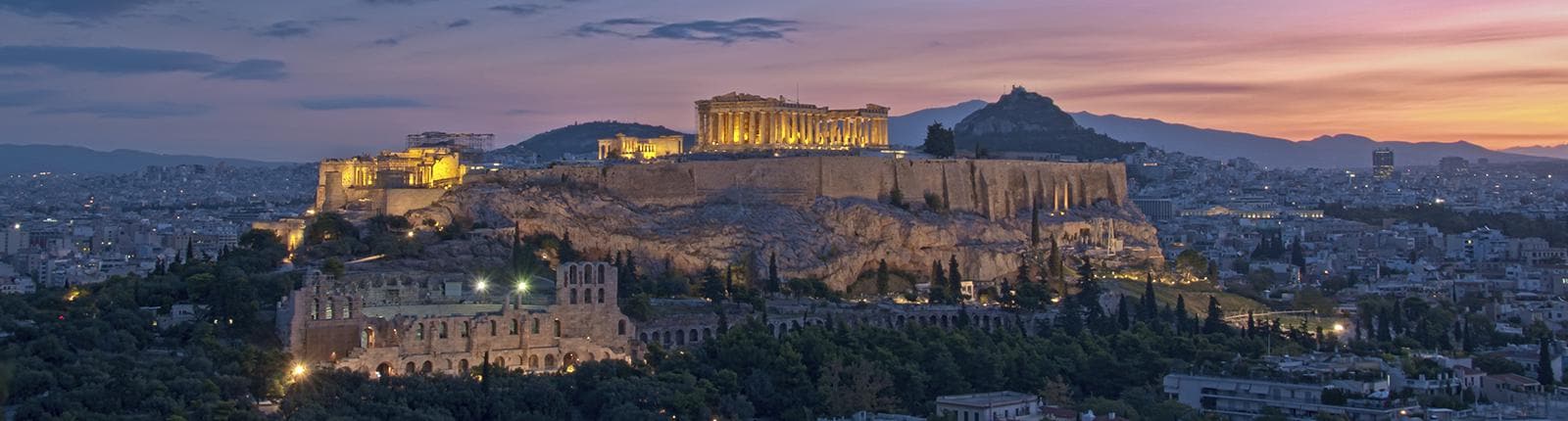 View of the Acropolis lit at dusk in Athens, Greece