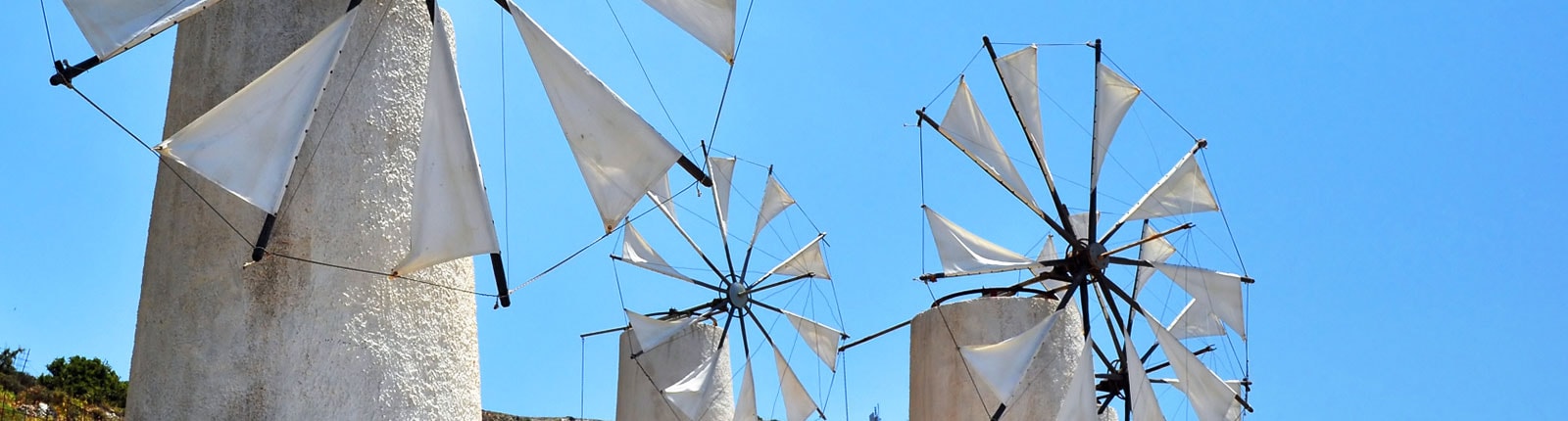 Windmills set against the blue sky in Crete, Greece