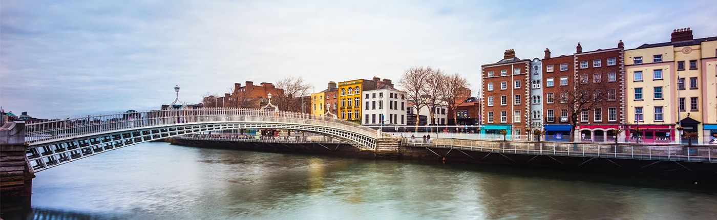 view of the ha'penny bridge and colorful buildings in dublin, ireland