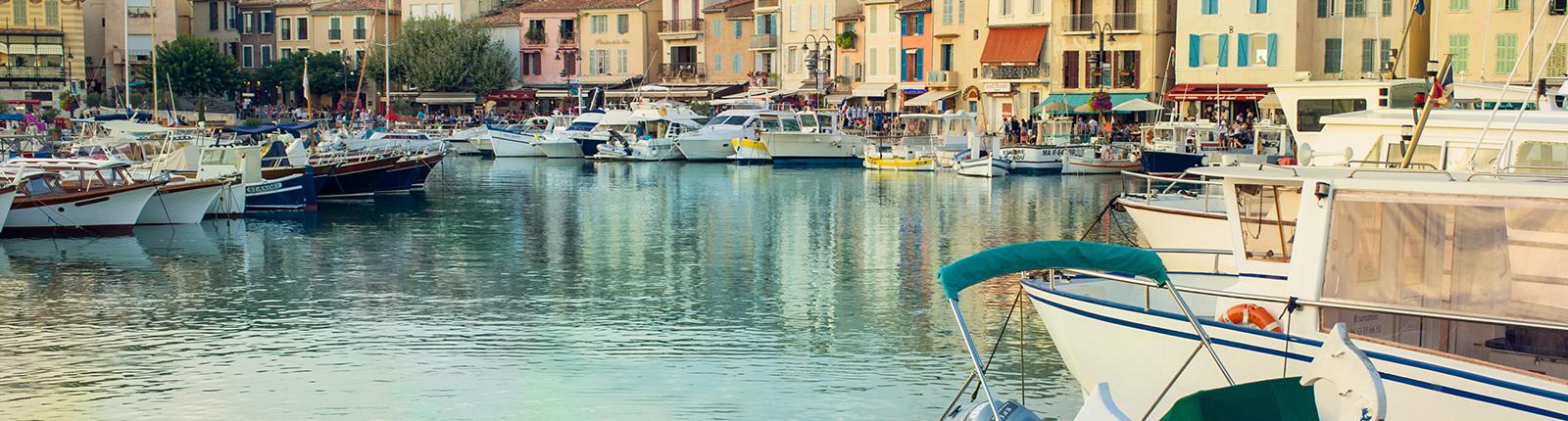 Boats docked along the waters edge in Marseilles, France