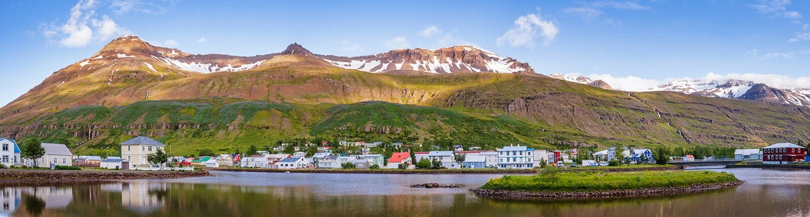 panoramic view of seydisfjordur, iceland with mountains in the background