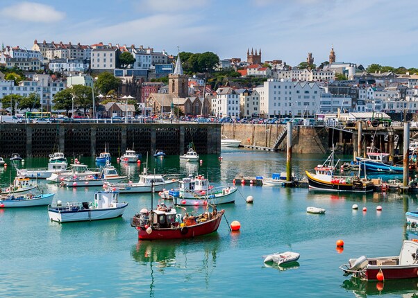 fising boats line the coast of st peter port