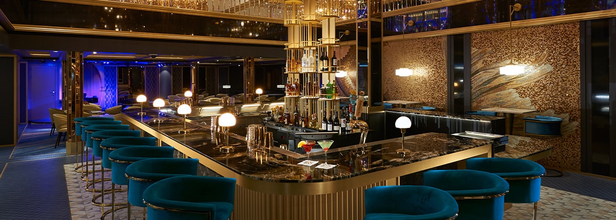 a gold accent bar with blue chairs surrounding the counter