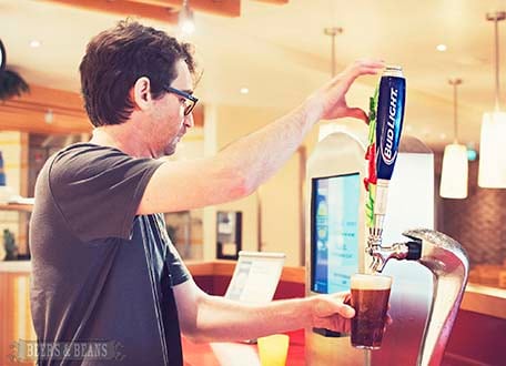 Randy pouring himself a beer at one of the beer stations on the Lido deck