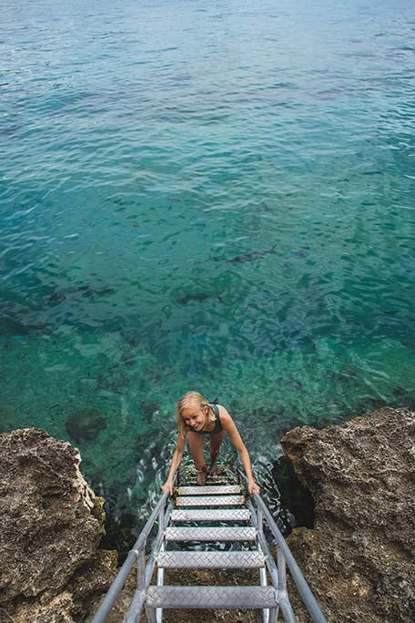 Hailey going down a ladder into the ocean