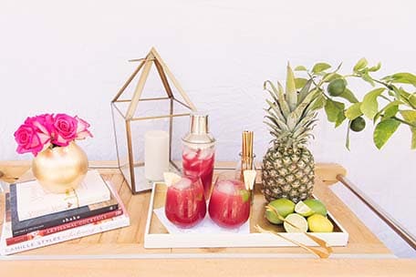 Sea breeze cocktail, fruits and flowers displayed on a wooden table