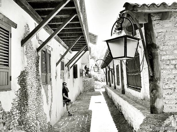 Black and white image of Randy leaning against a building in La Romana