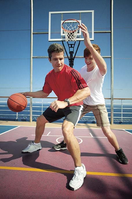 dad and son play basketball