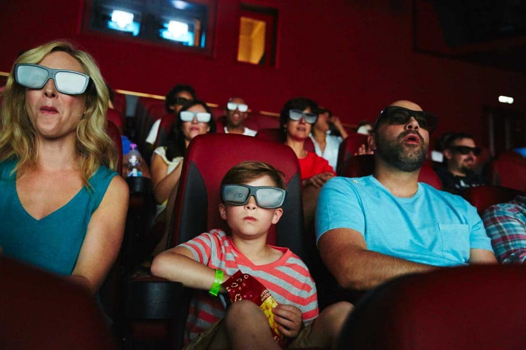 a family watching a movie at imax theater on board carnival horizon