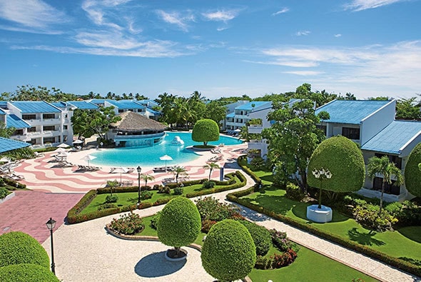 pool with a bar surrounded by luxury rooms at sunscape resort in puerto plata