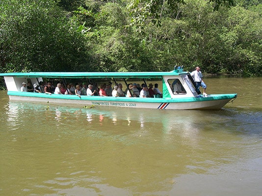 people sailing the tortuguero canals, exploring the jungle of limon