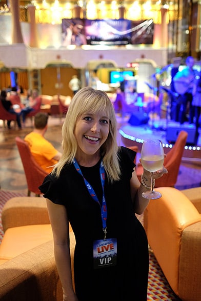 wife holding wine with vip badge