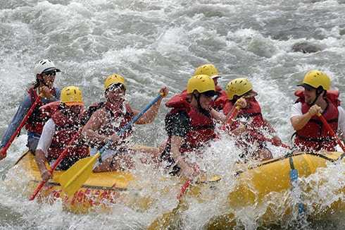 people white water rafting the powerful rapids of reventazon river