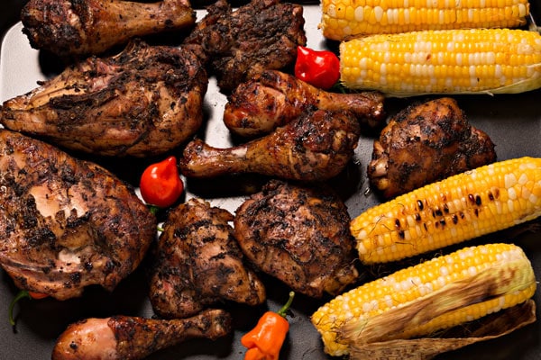 grilled jerk chicken with bonnet peppers and corn on the cob
