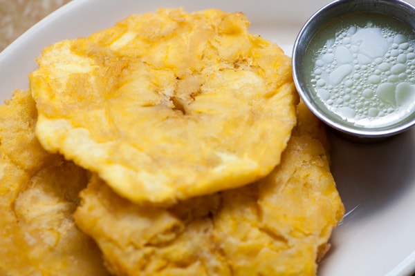 tostones from la romana, served with a green sauce