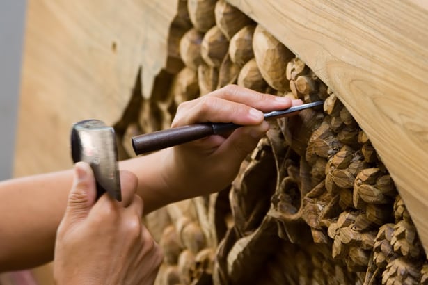 hand carving wood structure using chisel and hammer