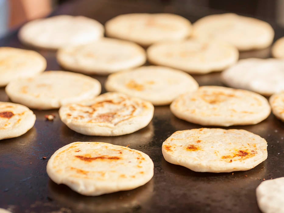 pupusas cooked on a griddle grill in mahogany bay