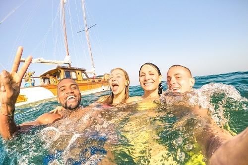 friends taking a selfie as the swim in the ocean off the coast of cozumel
