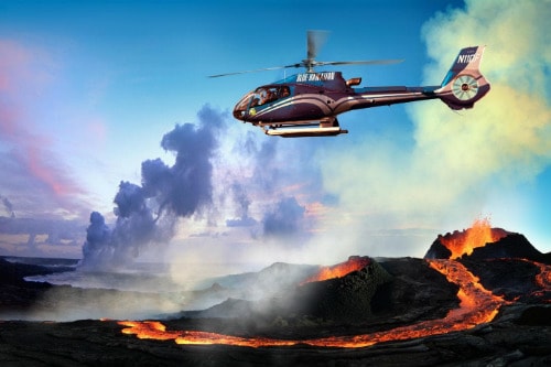 blue helicopter safely flying over the volcanic lava in hilo hawaii