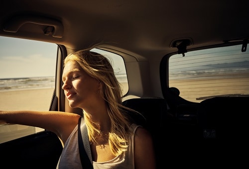 woman looking out the window during her private van trip