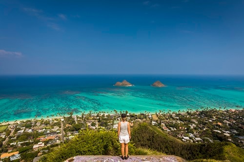 woman overlooking the amazing view of hawaiian island during an adventure hike 