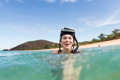 woman having fun snorkeling off the shore of kona hawaii 