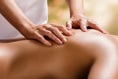 therapist massaging the back of a woman in cloud 9 spa 