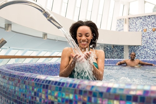 woman pouring water in the hydrotherapy pool from cloud 9 spa 