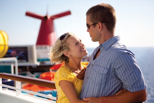 couple looking at each other on the deck of a carnival cruise ship