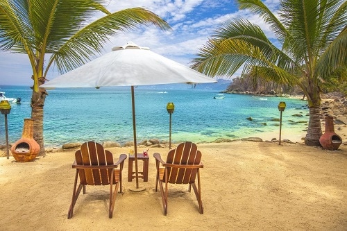 beach chairs and umbrella at the magical las caletas beach hideaway in puerto vallarta mexico