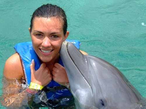 woman kissed by dolphin in grand cayman