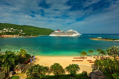 ocho rios bay beach with a carnival ship in the background