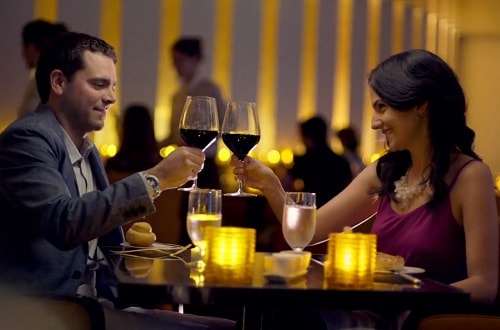 young couple having a romantic dinner onboard carnival legend 