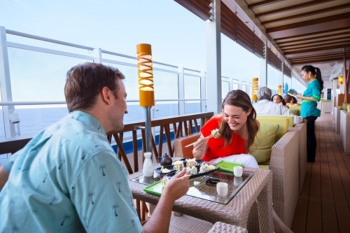 couple eating bonsai sushi with an ocean view onboard carnival vista 