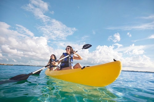 friends kayaking along the shore of the bahamas