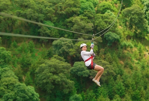 woman zip lining during a shore excursion in st lucia 