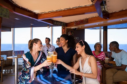 3 friends enjoying a few cocktails served at blueiguana tequila bar onboard carnival vista