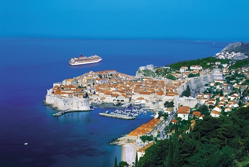 aerial view of the city of dubrovnik croatia as a carnival ship sails away