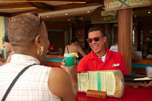 bartender serving a guest a cocktail during their cruise onboard carnival vista