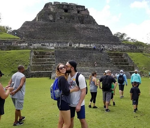 man kissing woman on the cheek as the pose in front of a mayan temple