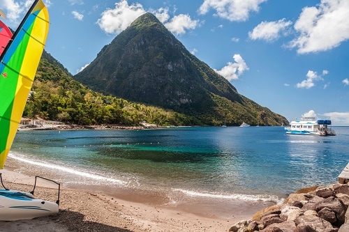 calm waters along the beach in st lucia with an amazing view of the mountains