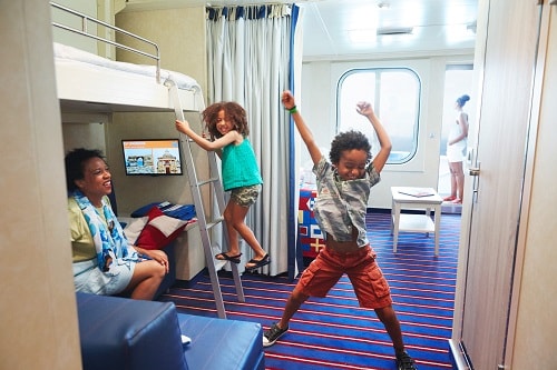 mom and her kids dancing in a carnival harbor stateroom