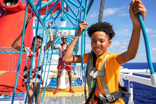 family having fun on the ropes course aboard a carnival ship