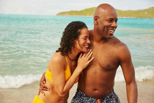 couple smiling together on a beach on an island
