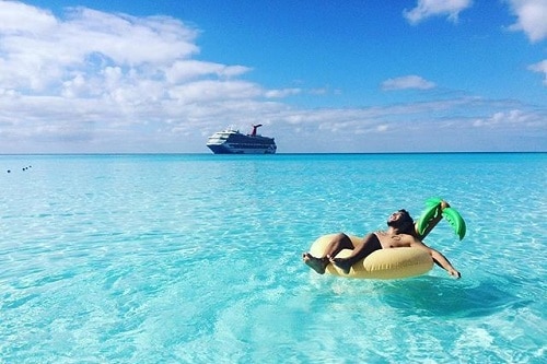 man relaxing on a floaty in the caribbean waters 