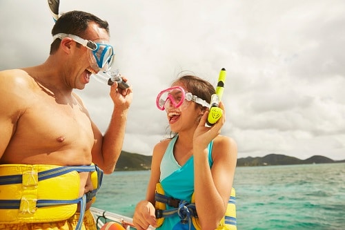 father and daughter happily ready to snorkel together