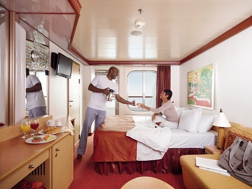 happy couple in a clean stateroom onboard a carnival ship