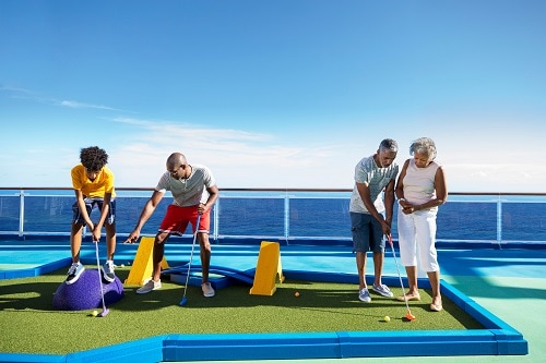 people playing mini golf onboard a carnival ship